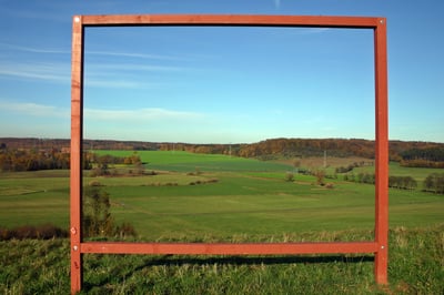 hills and fields through wooden frame
