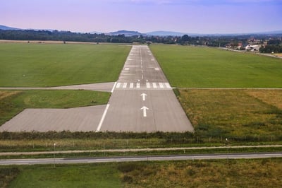 airport runway stretching toward mountains