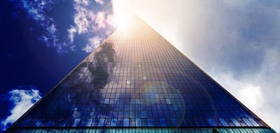 skyscraper stretches up into blue sky