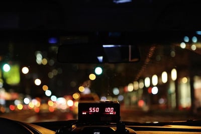 City at night through taxi windshield